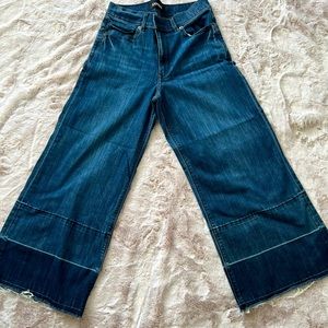 Express cropped wide leg jeans with raw hemline.